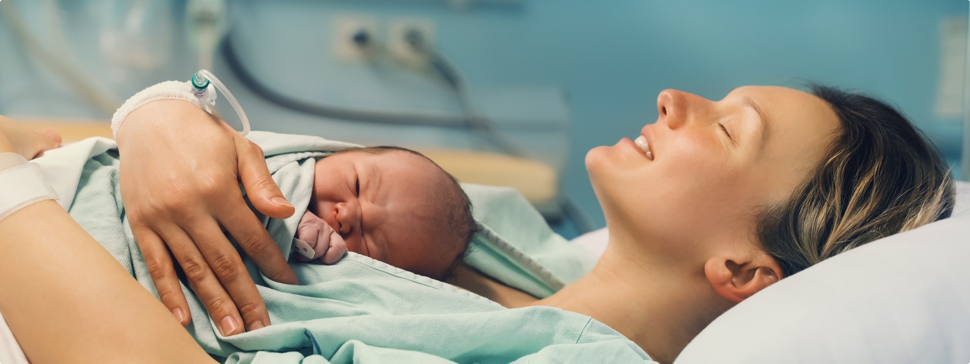 אישה לאחר לידה עם התינוק עליה