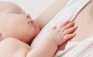 קלוז אפ על תינוק ישן על אימו